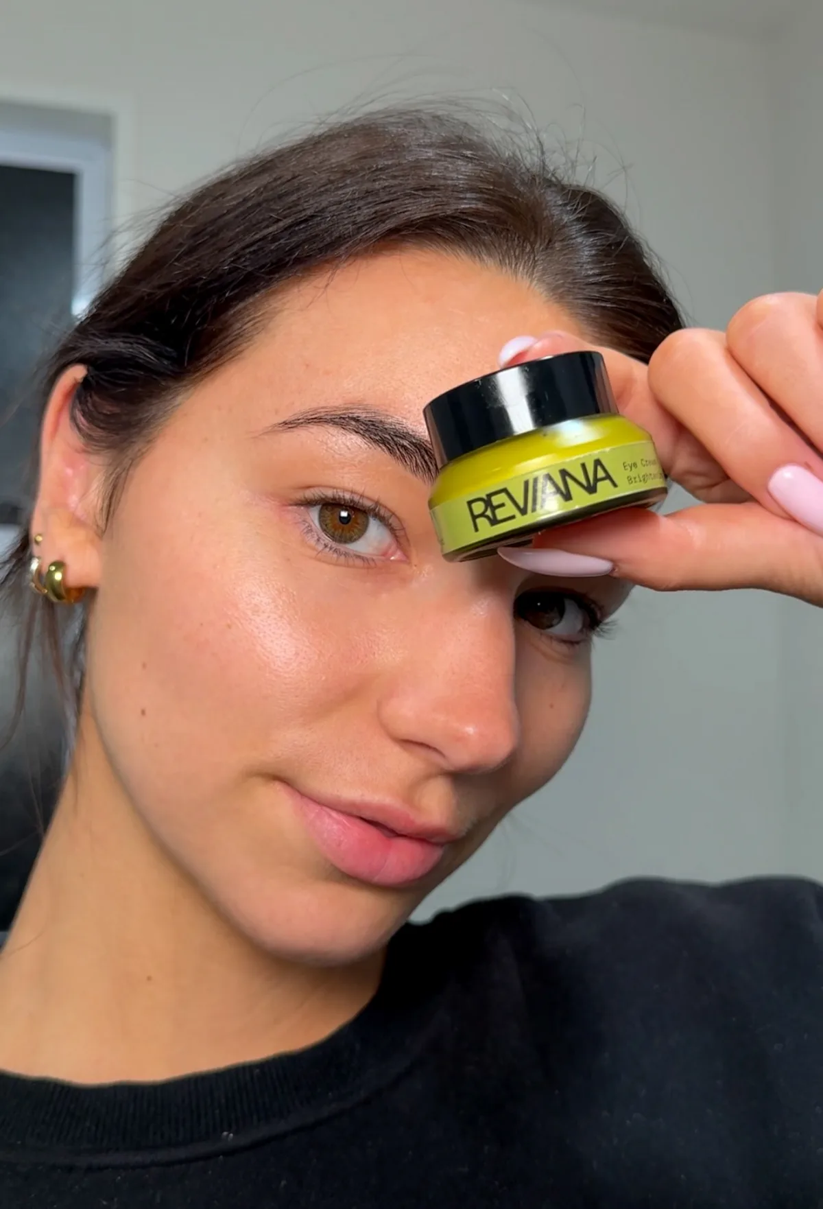 Applying Reviana Eye Cream around the eye area